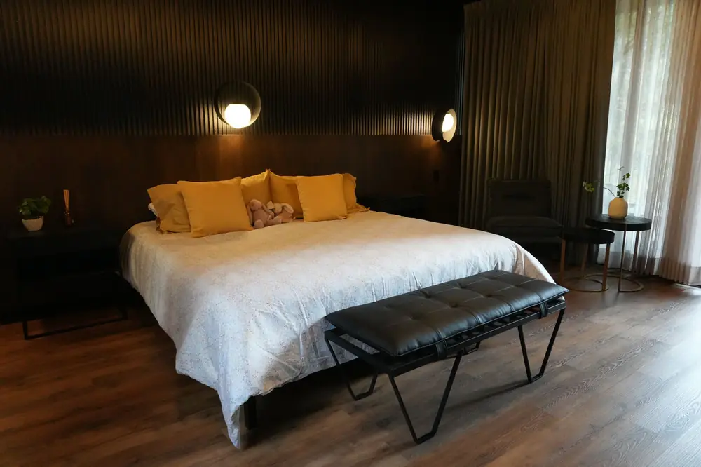 Recámara principal con cama king y banca de piel